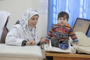 © UNRWA 2016 Photo by Mohammad Magayda A nurse measures Palestine refugee child weight at Irbid health Centre, Irbid, Jordan 